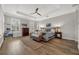 Bright main bedroom featuring a ceiling fan, hardwood floors, and large windows with shutters at 4533 Burke St, Orlando, FL 32814