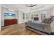 Bright main bedroom featuring a ceiling fan, hardwood floors, and large windows with shutters at 4533 Burke St, Orlando, FL 32814