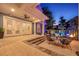 Covered patio area with seating, steps leading to the manicured lawn, and a pool area at 4533 Burke St, Orlando, FL 32814