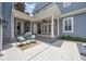 Covered patio featuring white pillars, a ceiling fan, and outdoor seating with bright blue cushions at 4533 Burke St, Orlando, FL 32814