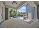View of a spacious covered patio with white pillars and outdoor furniture overlooking the backyard pool at 4533 Burke St, Orlando, FL 32814