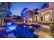 Lush backyard oasis featuring a pool, spa, fire pit, and manicured landscaping at twilight at 4533 Burke St, Orlando, FL 32814