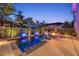 Stunning backyard pool featuring a fire pit, spa, and lush tropical landscaping at twilight at 4533 Burke St, Orlando, FL 32814