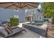 Backyard view of a shimmering pool and lounge chairs set beside the elevated spa and main home at 4533 Burke St, Orlando, FL 32814