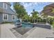 Backyard pool and spa featuring lush tropical landscaping, a fire pit, and ample seating areas at 4533 Burke St, Orlando, FL 32814