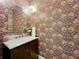 Stylish powder room with decorative wallpaper, vanity and gold fixtures at 4533 Burke St, Orlando, FL 32814