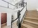 Bright foyer featuring an open staircase with wood treads and white spindles with black handrail at 4533 Burke St, Orlando, FL 32814