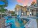 A stunning outdoor pool with water features, inviting lounge areas, and a spacious patio for relaxing and entertaining at 4533 Burke St, Orlando, FL 32814