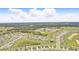 An aerial view of the community reveals rows of homes, green spaces, and nearby forested areas at 5226 Mahogany Dr, Mount Dora, FL 32757