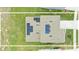 Aerial view of a home with solar panels on the roof and a well-maintained lawn at 5226 Mahogany Dr, Mount Dora, FL 32757