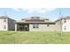 Well-maintained backyard with a covered patio, offering a serene outdoor space with efficient solar panels at 5226 Mahogany Dr, Mount Dora, FL 32757