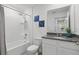 A well-lit bathroom with granite countertops, a bathtub-shower combo, and modern fixtures creates a functional space at 5226 Mahogany Dr, Mount Dora, FL 32757