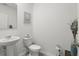 Clean, minimalist powder room with modern fixtures and decorative wall art at 5226 Mahogany Dr, Mount Dora, FL 32757