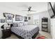 Cozy bedroom featuring sports memorabilia, a comfortable bed, and natural light from the window at 5226 Mahogany Dr, Mount Dora, FL 32757