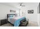 A cozy bedroom with large bed, ceiling fan, carpet and a connected bathroom creates a relaxing retreat at 5226 Mahogany Dr, Mount Dora, FL 32757