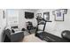 Exercise room features a couch and television, weight-lifting equipment, and a Nautilus treadmill at 5226 Mahogany Dr, Mount Dora, FL 32757