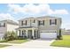 Charming two-story home with a well-kept lawn, lovely landscaping and an attached two car garage at 5226 Mahogany Dr, Mount Dora, FL 32757
