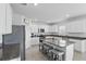 A spacious kitchen featuring white cabinets, a large island, and stainless steel appliances at 5226 Mahogany Dr, Mount Dora, FL 32757
