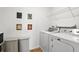 Laundry room with modern appliances and decor makes chores easy with plenty of space for cleaning supplies at 5226 Mahogany Dr, Mount Dora, FL 32757