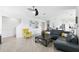 Open-concept living room with neutral tones, stylish furnishings, and modern ceiling fan at 5226 Mahogany Dr, Mount Dora, FL 32757