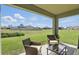 Covered patio with comfortable seating and view of a green space at 5226 Mahogany Dr, Mount Dora, FL 32757