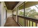Enclosed balcony with wood railings, neutral carpeting, and view of trees at 600 Northern Way # 404, Winter Springs, FL 32708