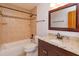 Bathroom features a granite countertop vanity, toilet, and a tiled tub and shower at 600 Northern Way # 404, Winter Springs, FL 32708