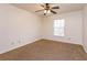 Carpeted bedroom with a ceiling fan and window allowing for natural light at 600 Northern Way # 404, Winter Springs, FL 32708