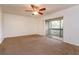 Neutral bedroom features sliding glass door access to private balcony and a ceiling fan at 600 Northern Way # 404, Winter Springs, FL 32708