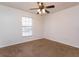 Carpeted bedroom with a ceiling fan and window allowing for natural light at 600 Northern Way # 404, Winter Springs, FL 32708