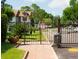 Gated entrance to a residential area, featuring 24/7 surveillance signage at 600 Northern Way # 404, Winter Springs, FL 32708