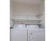 Laundry room with side-by-side washer and dryer, and white shelving at 600 Northern Way # 404, Winter Springs, FL 32708