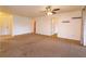 Spacious living room featuring neutral carpet, ceiling fan, and ample natural light at 600 Northern Way # 404, Winter Springs, FL 32708