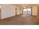 Spacious living room featuring plush carpeting and natural light from the sliding glass door at 600 Northern Way # 404, Winter Springs, FL 32708