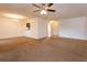 Inviting living room boasts neutral carpet, modern ceiling fan, and elegant chandelier at 600 Northern Way # 404, Winter Springs, FL 32708