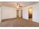 Neutral main bedroom with a ceiling fan, closet, and ensuite bathroom access at 600 Northern Way # 404, Winter Springs, FL 32708