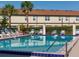 Community pool with lounge chairs and beautiful palm trees that create a serene outdoor living at 600 Northern Way # 404, Winter Springs, FL 32708