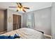 Cozy bedroom with wood-look flooring, ceiling fan, window, and closet with paneled doors at 6819 Westborough Ln, Orlando, FL 32818