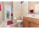 Bright bathroom with a sink, toilet, and access to the outdoors at 6942 Remington View Ct, Orlando, FL 32829