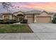 Charming single-story home with a well-manicured lawn and a spacious three-car garage at 6942 Remington View Ct, Orlando, FL 32829