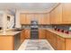 Well-equipped kitchen featuring granite counters, mosaic backsplash, and wood cabinets at 6942 Remington View Ct, Orlando, FL 32829