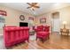 Comfortable living room with stylish red seating, ceiling fan, and wood-look floors at 6942 Remington View Ct, Orlando, FL 32829