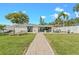 Spacious backyard with ample patio space, green lawn, and direct access to water at 716 Palm Circle Dr, Port Orange, FL 32127