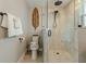 Clean bathroom featuring a glass enclosed shower, toilet, and a decorative towel rack at 716 Palm Circle Dr, Port Orange, FL 32127