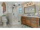 Beautiful bathroom with a glass shower, wood vanity, and a large mirror at 716 Palm Circle Dr, Port Orange, FL 32127