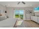 Primary bedroom with patio access, wood-look flooring, and backyard water views at 716 Palm Circle Dr, Port Orange, FL 32127