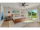 Bedroom with wood look flooring, sliding glass doors to patio, and a ceiling fan at 716 Palm Circle Dr, Port Orange, FL 32127