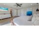 Spacious bedroom featuring a king bed, a TV, and a door leading to an ensuite bathroom at 716 Palm Circle Dr, Port Orange, FL 32127
