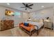 Bright bedroom featuring a bed with colorful pillows, a TV, and a wooden dresser at 716 Palm Circle Dr, Port Orange, FL 32127