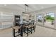 Dining room with large table, arcade game, and sliding glass doors to the patio at 716 Palm Circle Dr, Port Orange, FL 32127